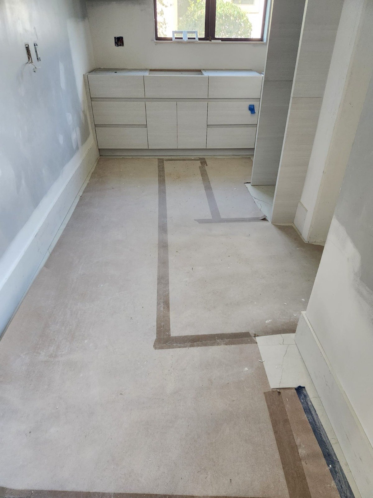 Bathroom stripped to the subfloor during a layout change