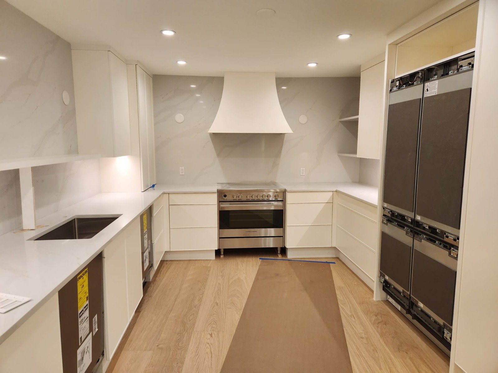 Finished kitchen with recessed lighting and custom hood in a Coconut Creek remodel