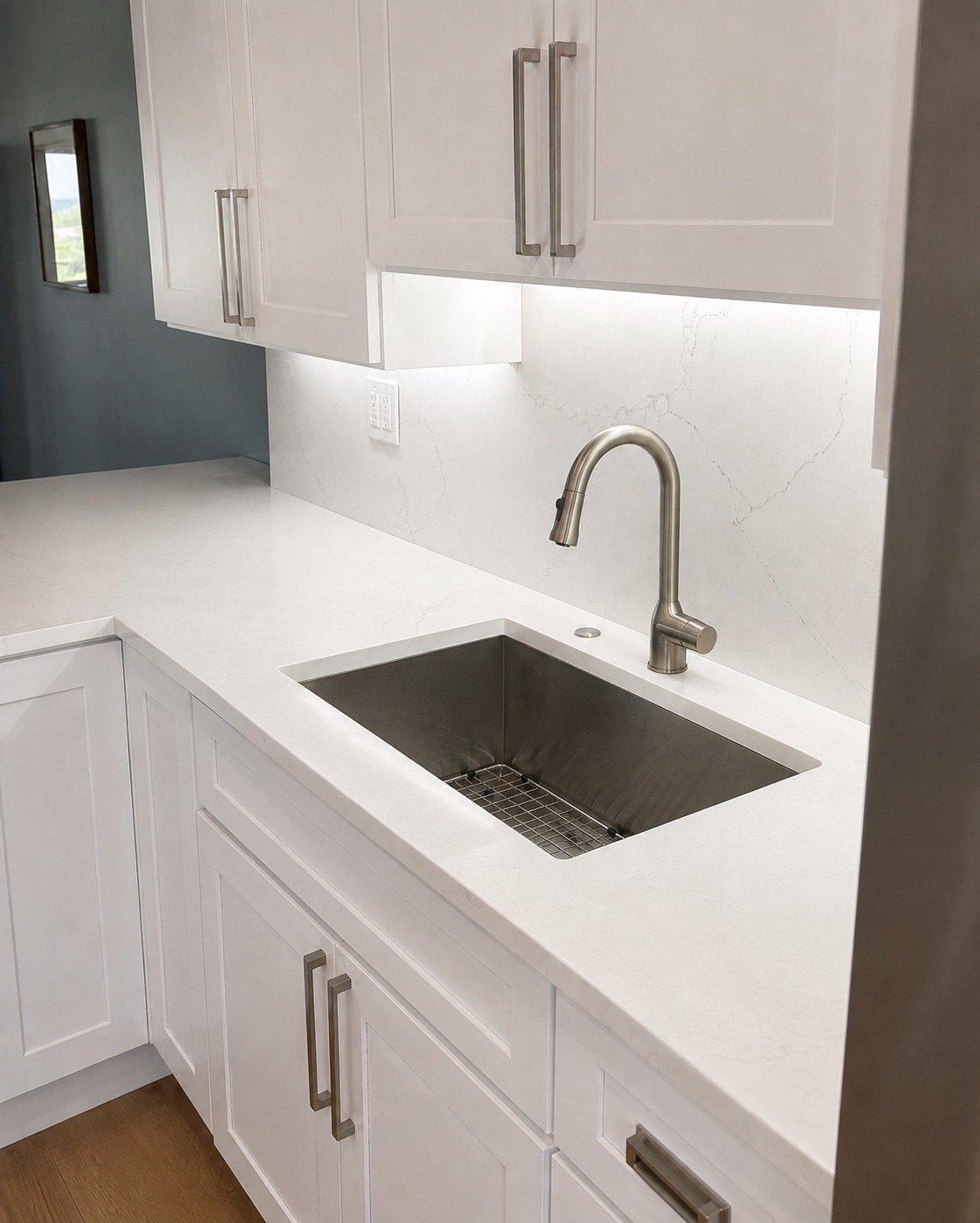 Undermount stainless sink and quartz counter in a remodeled Wilton Manors kitchen