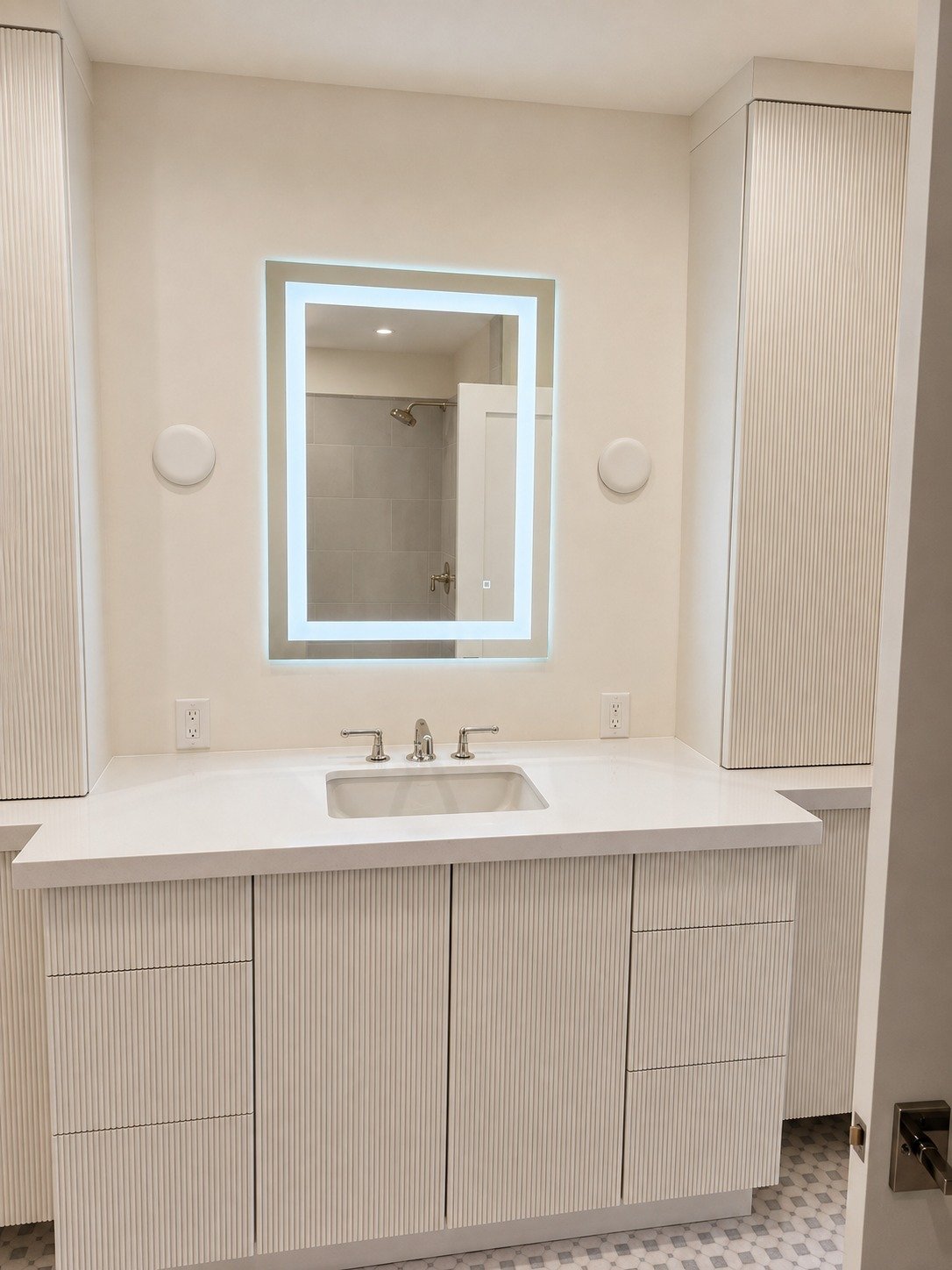 Floating vanity with quartz top, undermount sink and backlit LED mirror