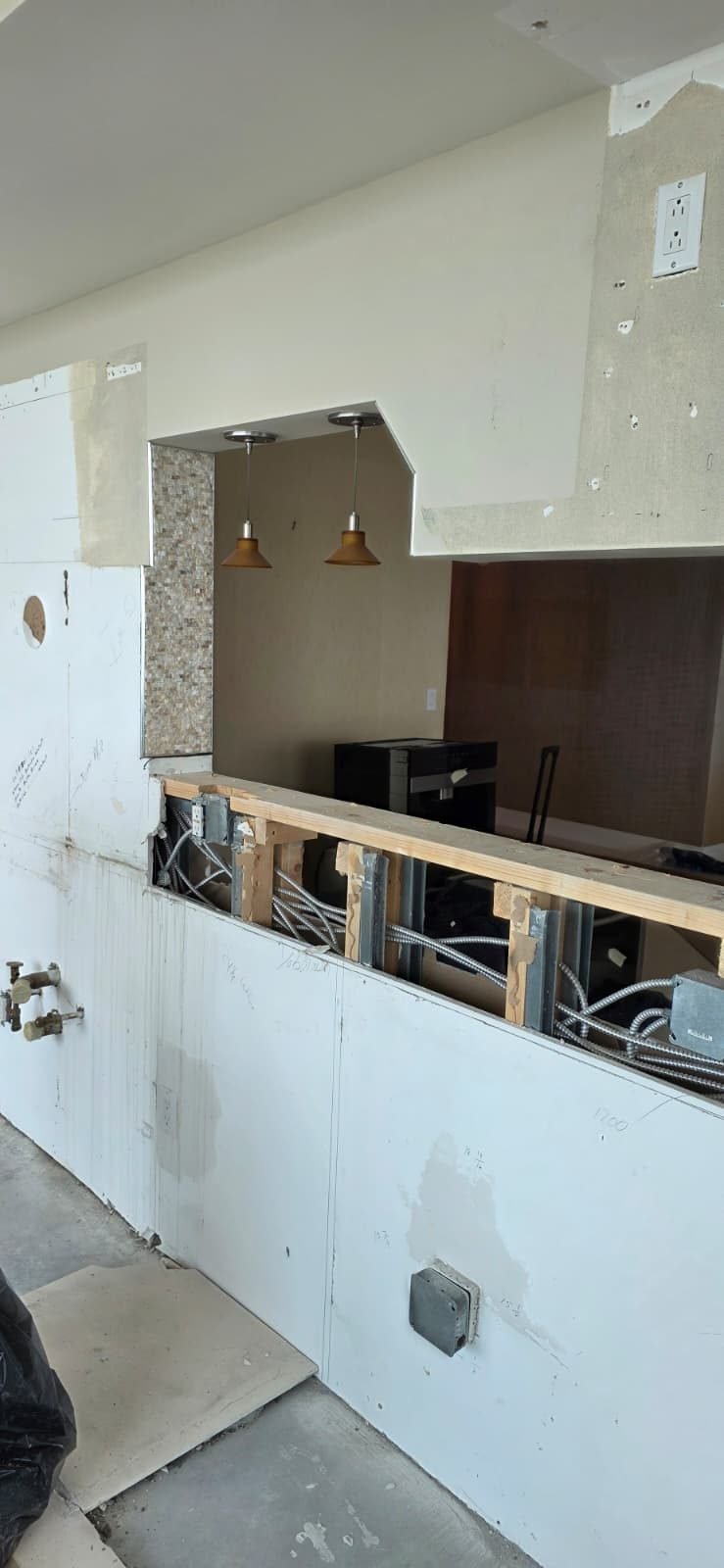 Condo kitchen pass-through framed and prepped before new cabinets and countertop