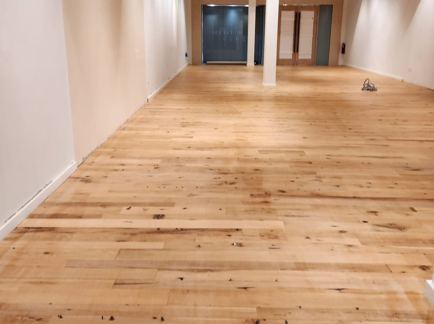 Newly installed wide-plank wood flooring across an open room in Fort Lauderdale