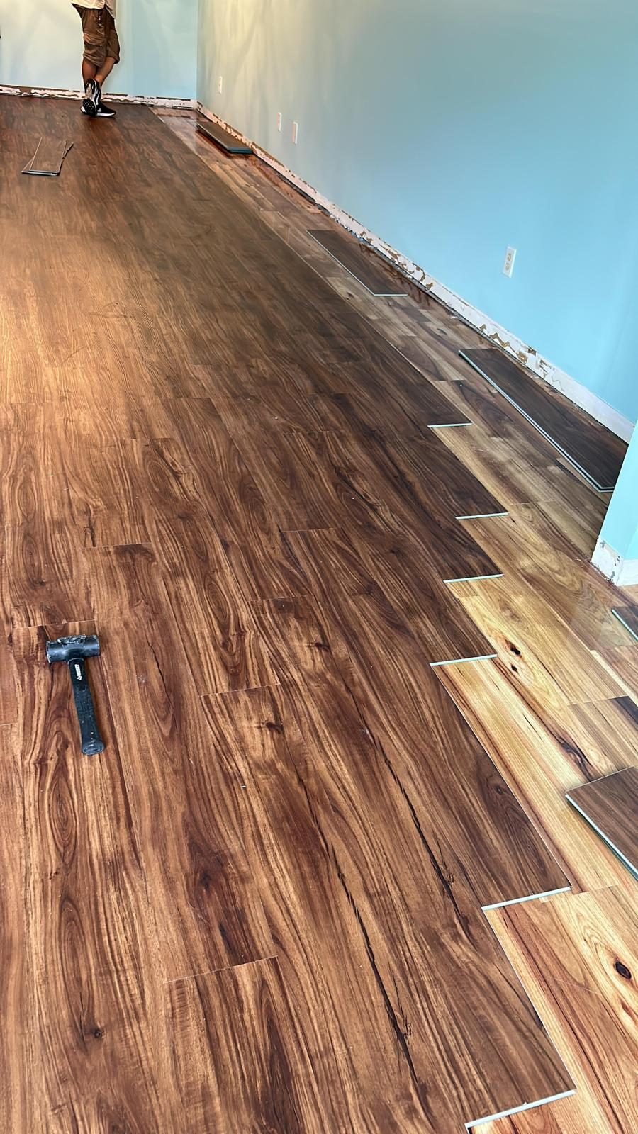 Solid wood plank flooring being installed across a Fort Lauderdale living room