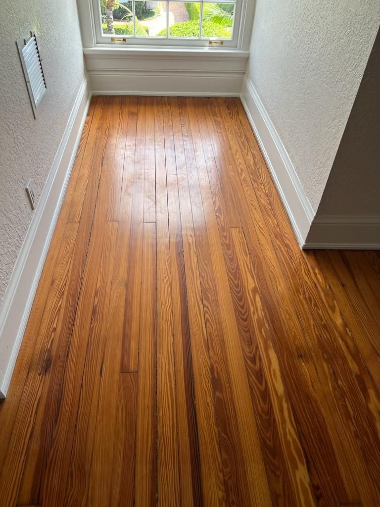 Refinished heart pine floor with a warm satin finish in an older South Florida home
