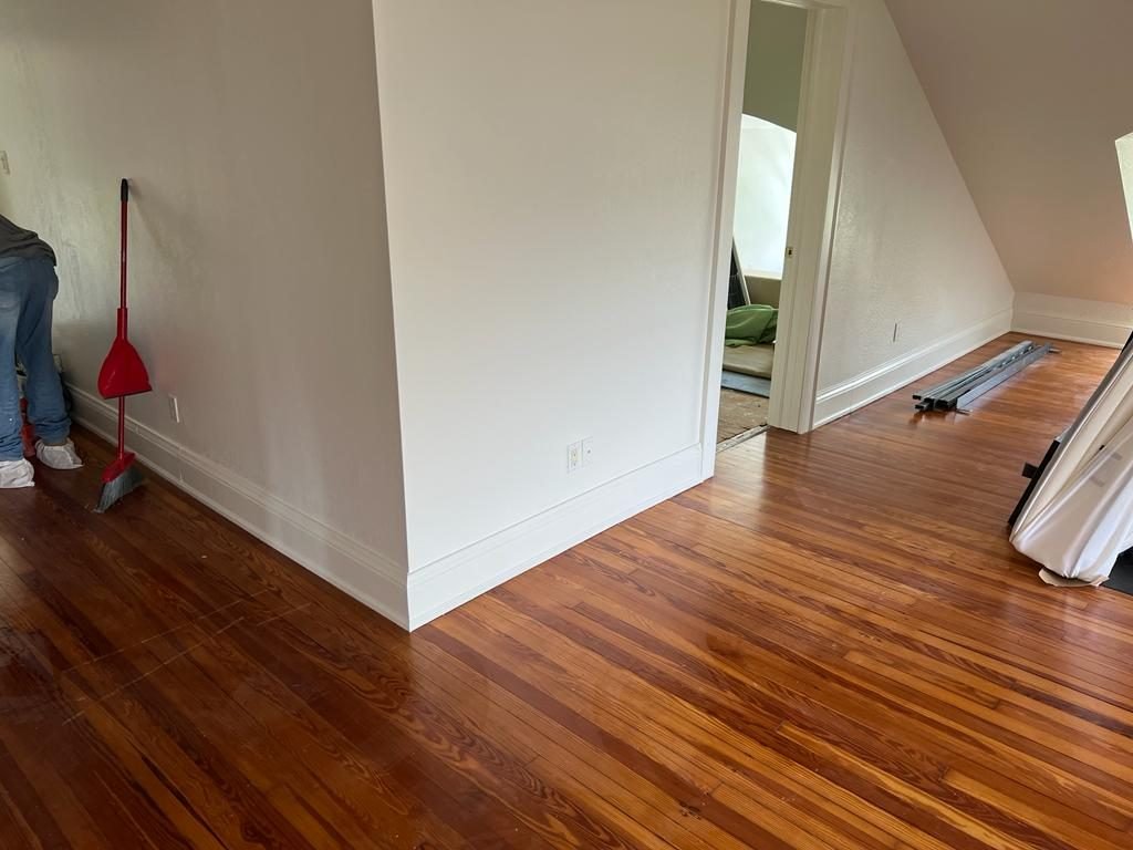 Restored heart pine flooring running through a hallway and bedroom
